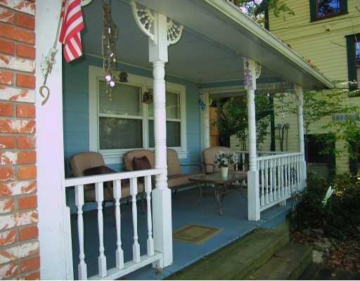 Front porch with turn-of-20th-Century railing accented in blue