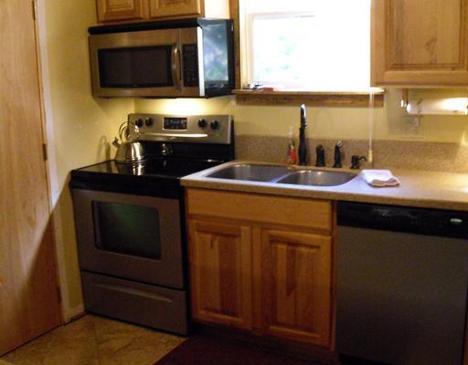 The kitchen featuring up-to-date appliances and sink